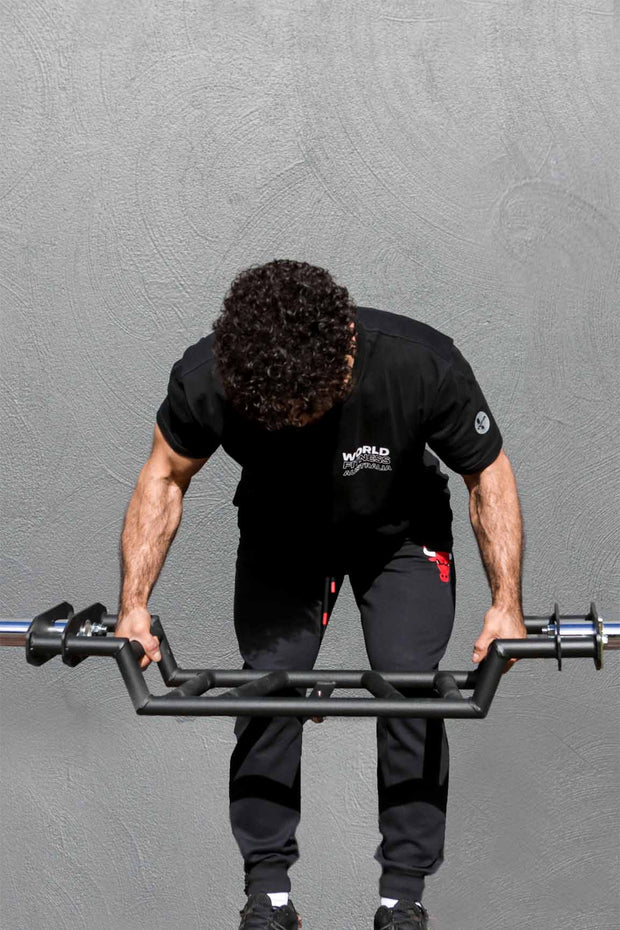 Male performing bent of row with Body Iron Cambered Swiss bar