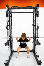 female doing squat on smith machine