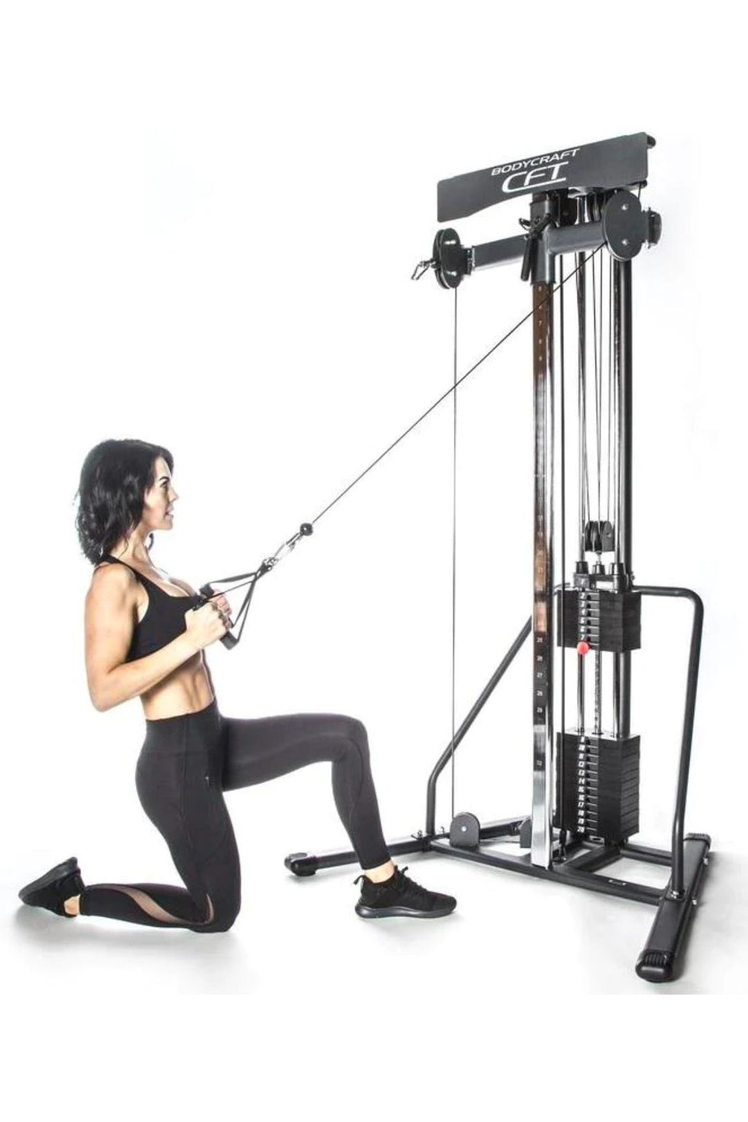 Brunette woman doing cable lat pull down on functional trainer