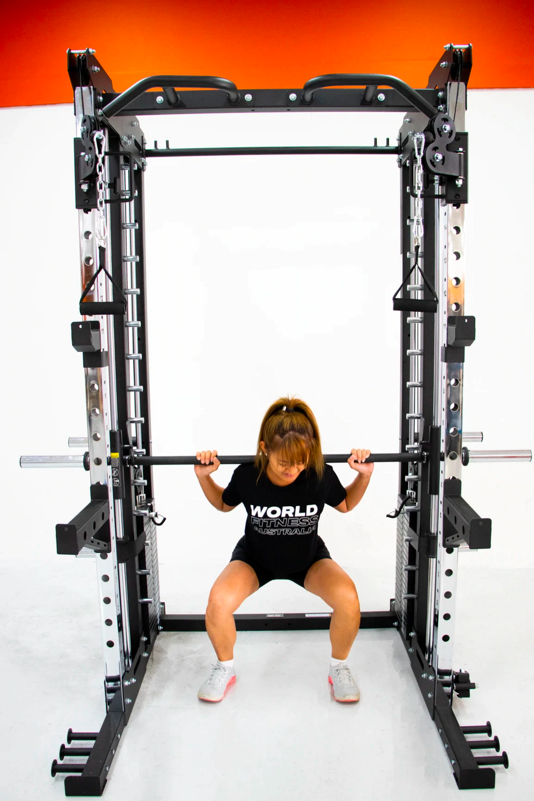 female doing squats on smith machine functional trainer