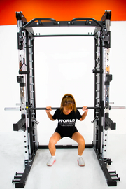 female doing squats on smith machine functional trainer
