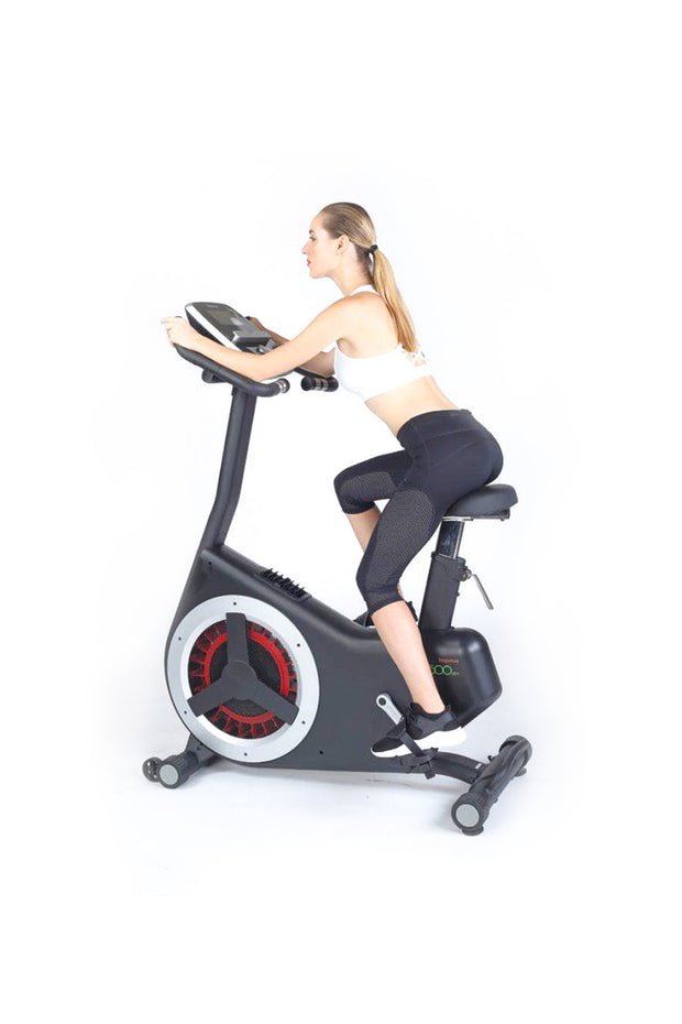 female riding red and black upright bike