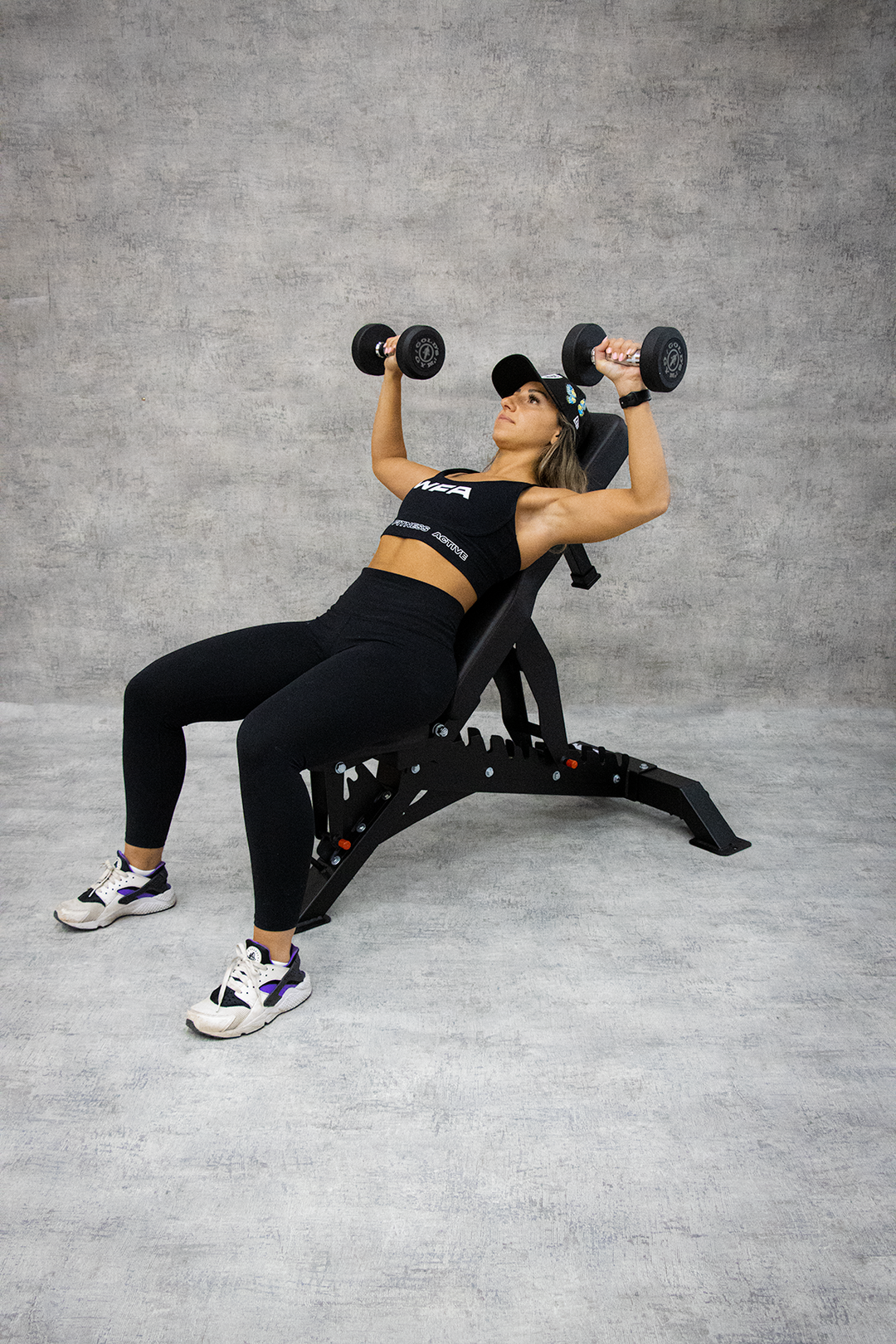 woman performing incline dumbbell press 