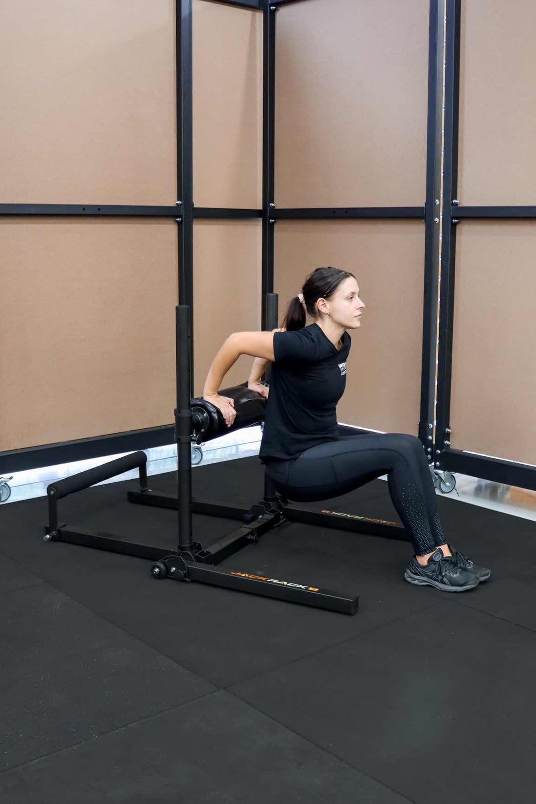 Female doing tricep dips of foot roller exercise stand