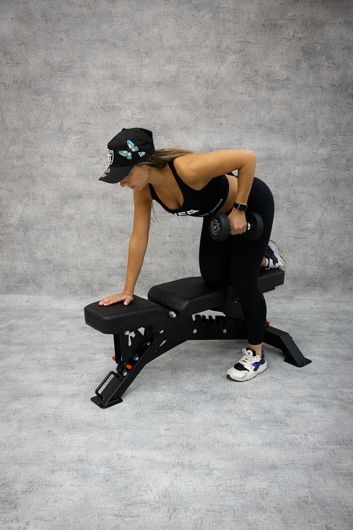 woman performing single arm bent over row