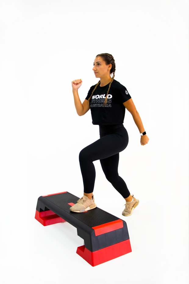 female stepping onto black and red aerobic step