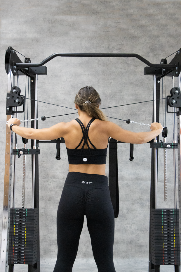Female performing cable back pulls on a functional trainer
