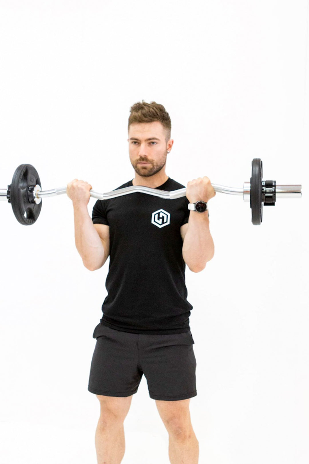 Man performing bicep curls with silver ez curl bar and black weight plates