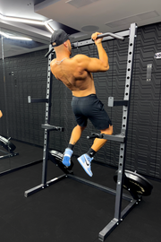 Man doing a pull up on half rack
